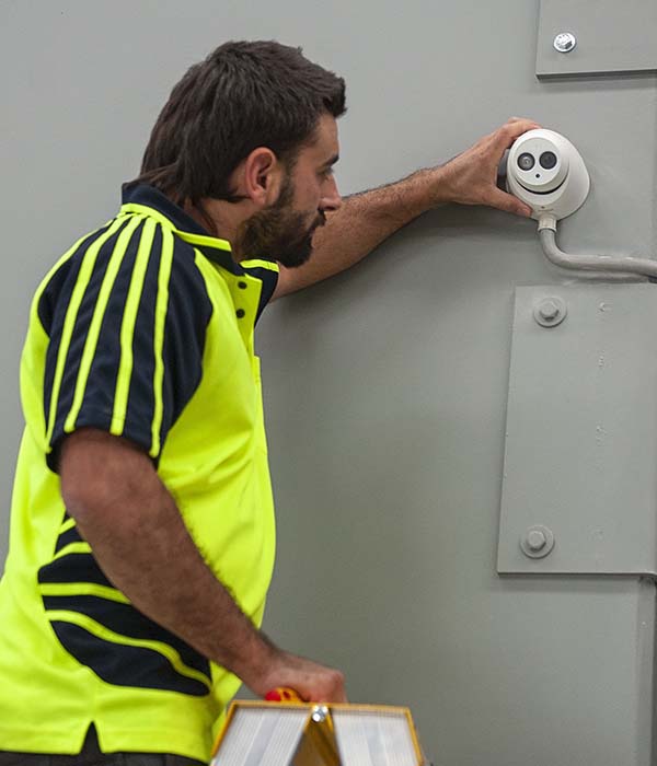 best electricians Perth - Fixing CCTV camera in a commercial building